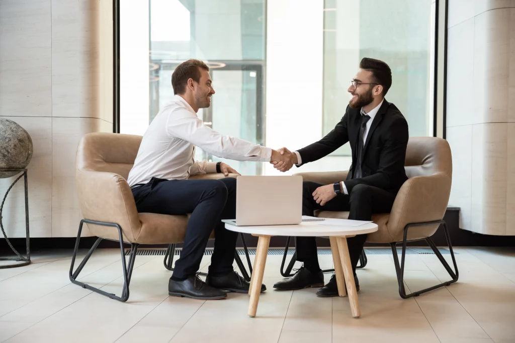 manager and employee shaking hands after a welfare meeting where the manager benefitted from the emberscale post about how to conduct a welfare meeting