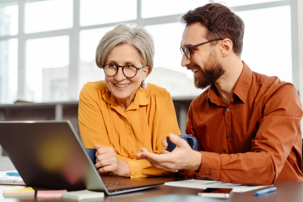 a young seo consultant and business owner looking at a laptop covering exactly how to appear on google search