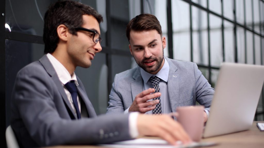 two business men reviewing which hr firm to choose for compliance support