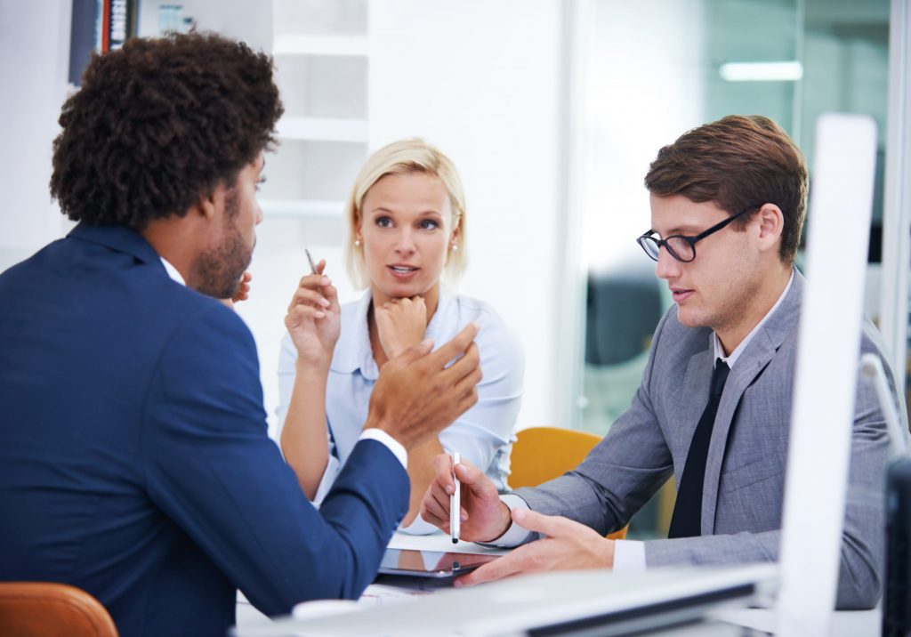 A manager discussing with her two staff members how to get equipment back from a fired employee