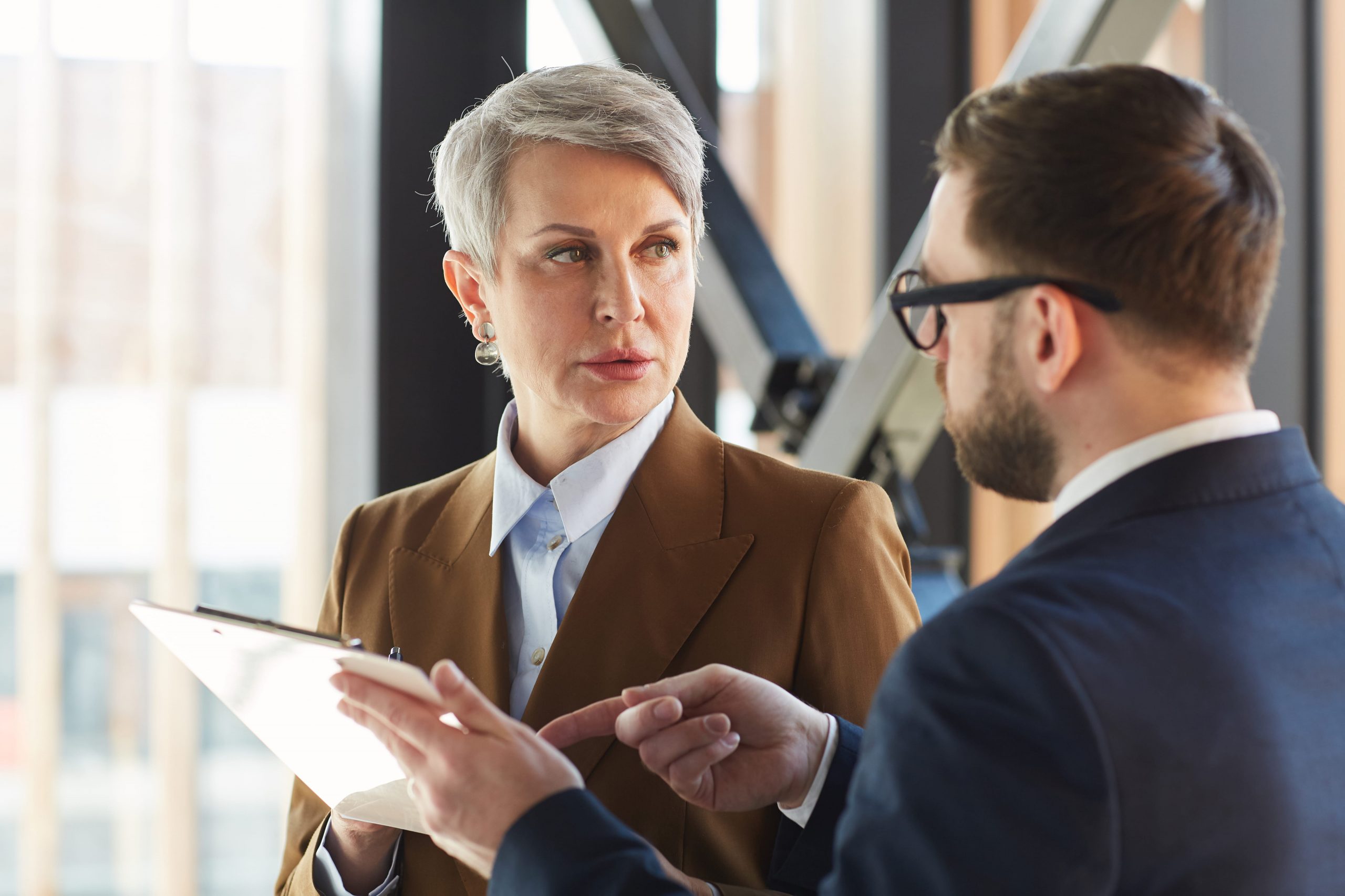 A manager discussing with her employee how to get equipment back from a terminated employee